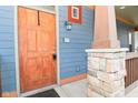 Inviting front entrance with a wooden door and a stone support post at 1635 N College Ave # 4, Indianapolis, IN 46202