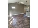 Spacious living room featuring vaulted ceiling, modern light fixtures, and wood-look flooring at 1635 N College Ave # 4, Indianapolis, IN 46202