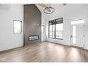 Bright living room with vaulted ceilings, sleek fireplace, wood floors, and large windows at 1663 Fernley Dr, Westfield, IN 46074