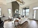 Bright living room features a fireplace, large windows, and modern furnishings for stylish comfort at 1663 Fernley Dr, Westfield, IN 46074