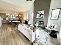 Open-concept living room showcasing fireplace, modern decor, and seamless flow to the kitchen at 1663 Fernley Dr, Westfield, IN 46074