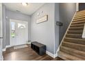 Welcoming entryway featuring hard wood floors, coat storage and convenient access to the staircase at 1893 Devonshire Ave, Avon, IN 46123