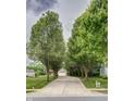 Long driveway framed by mature trees. The property also includes a well-maintained lawn and a shed at 19187 Outer Bank Rd, Noblesville, IN 46062