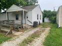 View of the home's side yard, showing the driveway and detached garage at 1943 N Drexel Ave, Indianapolis, IN 46218