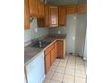 Functional kitchen with wood cabinets and stainless steel sink at 1943 N Drexel Ave, Indianapolis, IN 46218
