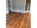 Living room with original hardwood floors leading to the kitchen at 1943 N Drexel Ave, Indianapolis, IN 46218