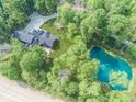 A stunning aerial view of the property, showcasing the house, lush greenery, a pond and surrounding landscape at 2004 Layton Rd, Anderson, IN 46011