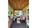 Cozy front porch featuring comfortable seating, a small table, and charming decor at 2032 N Auburn St, Speedway, IN 46224