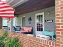 Inviting front porch with brick accents, outdoor seating, and decorative elements at 2032 N Auburn St, Speedway, IN 46224