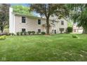 Charming two-story home with a manicured lawn and mature trees at 233 Saddlebrook Dr, Zionsville, IN 46077