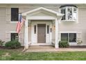 Inviting front entrance with an American flag at 233 Saddlebrook Dr, Zionsville, IN 46077