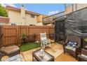 Cozy backyard patio with comfortable seating, turf, and an enclosed structure, perfect for relaxing outdoors at 2766 Del Prado Dr # 6, Indianapolis, IN 46227