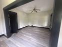 An open living room features new floors, fresh paint, and a ceiling fan at 2826 Station St, Indianapolis, IN 46218