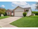 A well maintained lawn and driveway lead to the attached two car garage of this home at 293 E Quail Wood Ln, Westfield, IN 46074