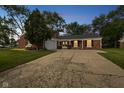 Exterior front of home with landscaped yard, brick facade and attached garage at 3148 Arbutus Dr, Indianapolis, IN 46224