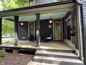 Inviting covered front porch with starburst pendant lighting and ample seating for relaxing and entertaining at 321 N Rangeline Rd, Carmel, IN 46032