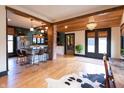 Spacious open-concept living area featuring exposed wood beams, hardwood floors, and modern decor at 321 N Rangeline Rd, Carmel, IN 46032