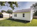 Home featuring a big backyard, a detached garage, and small deck at 321 S Biltmore Ave, Indianapolis, IN 46241