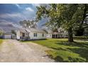 Traditional home with gravel driveway and green lawn at 321 S Biltmore Ave, Indianapolis, IN 46241