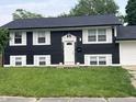 Two story home featuring a dark exterior and white shutters with an attached garage at 3949 Chateau Dr, Indianapolis, IN 46226