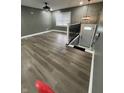 Open floor plan living room featuring modern lighting, grey walls, and wood floors at 3949 Chateau Dr, Indianapolis, IN 46226