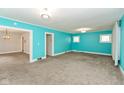 Open-concept living room with gray carpet and views into adjoining rooms at 4048 N College Ave, Indianapolis, IN 46205
