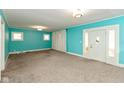 Bright and spacious living room with a neutral carpet and large windows at 4048 N College Ave, Indianapolis, IN 46205