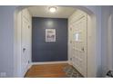 Welcoming foyer featuring hardwood floors, fresh paint, and a classic front door at 5435 E 10Th St, Indianapolis, IN 46219