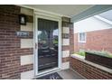 Inviting front porch showcasing brick accents, a stylish front door, and a cozy outdoor space at 5435 E 10Th St, Indianapolis, IN 46219