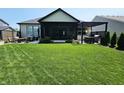 Spacious backyard features a covered patio, pergola, and well-maintained lawn at 5686 Ellie Ct, Noblesville, IN 46062