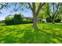 Well-maintained single-story home featuring a vibrant green lawn and mature landscaping for enhanced curb appeal at 623 Circle Ct, Whiteland, IN 46184