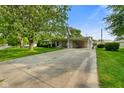 Charming single-story home featuring a well-manicured lawn, mature tree, and a convenient attached carport at 623 Circle Ct, Whiteland, IN 46184