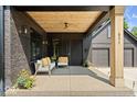 Inviting front porch with comfortable seating, wooden ceiling detail, and contemporary design elements at 631 1St Nw Ave, Carmel, IN 46032