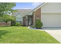 Well-maintained home featuring manicured lawn, landscaping, and brick facade, creating a welcoming curb appeal at 6529 Lakesedge Dr, Indianapolis, IN 46237