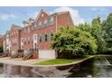Brick townhouse with green shutters, attached garage, and manicured lawn at 755 Ivy Ln, Carmel, IN 46032