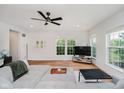 Cozy living room featuring hardwood floors, bright windows, and ceiling fan at 755 Ivy Ln, Carmel, IN 46032
