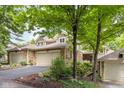 An inviting townhome boasting a stone facade, two-car garage, and well-maintained landscaping at 8133 Lower Bay Ln, Indianapolis, IN 46236