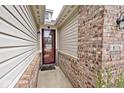 Close-up shot of the front entryway shows beautiful brickwork and stylish decor leading to the warm, inviting home at 8176 Crumwell Dr, Avon, IN 46123