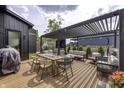 Outdoor deck with pergola featuring comfortable seating, dining table, and grill at 8695 Morgan Dr, Fishers, IN 46038