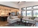 Open concept living room with high ceilings, large windows, and a view into the modern kitchen at 0 Legacy Estates Lot 2, Mooresville, IN 46158