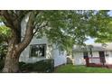 Charming home exterior with a large tree providing shade at 1018 Jefferson Ave, Indianapolis, IN 46201