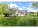 Expansive backyard featuring lush greenery, well-maintained lawn, mature trees and patio space at 1051 Arrowwood Dr, Carmel, IN 46033
