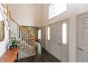 Bright entryway with hardwood floors, staircase, and large front doors at 1120 Mill Run Overlook, Noblesville, IN 46062
