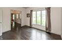 A serene room with hardwood floors, a large window, and neutral-toned walls at 1120 Mill Run Overlook, Noblesville, IN 46062