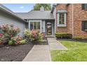 Inviting home entrance with a walkway leading to a beautiful flower garden at 13153 Tudor Dr, Carmel, IN 46033