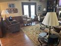 Inviting living room features a fireplace, wood paneling, and plush seating at 13736 Langley Dr, Carmel, IN 46032