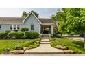 Beautifully landscaped home with a stone walkway and green lawn at 1437 Shannon Ave, Indianapolis, IN 46201