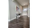 Hallway with dark wood floors, neutral walls, and decorative console table at 15873 Hush Hickory Bnd, Westfield, IN 46074