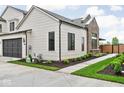 Charming home featuring sleek black window frames, a dark garage door, and a well-manicured lawn at 1677 Solebar Way, Westfield, IN 46074