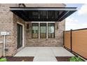 Charming front porch featuring brick accents, a covered entryway, and contemporary design elements at 1677 Solebar Way, Westfield, IN 46074